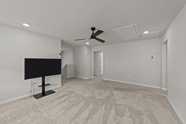 unfurnished living room featuring attic access, recessed lighting, a ceiling fan, light colored carpet, and baseboards