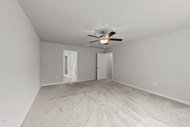 unfurnished bedroom featuring carpet, baseboards, and a ceiling fan