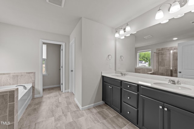 full bathroom with double vanity, a bath, baseboards, and a shower stall