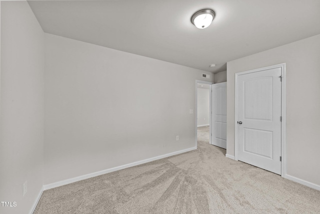 unfurnished bedroom with carpet floors and baseboards