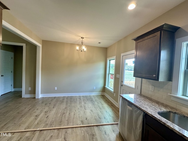 1458 Union Grove Church Rd, Fremont, NC 27830 - unfurnished dining area with a chandelier, light wood finished floors, baseboards, and a sink