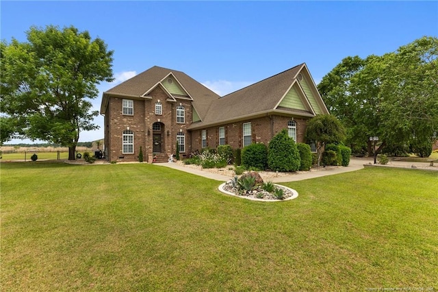 traditional-style house with brick siding and a front lawn