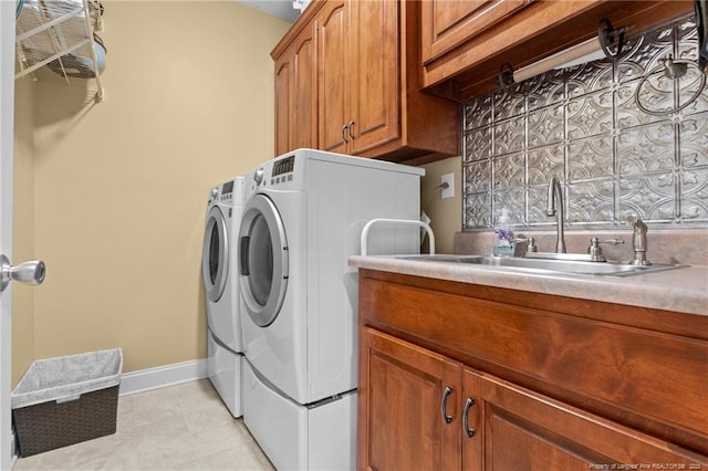 laundry room featuring cabinet space, washer and clothes dryer, and baseboards