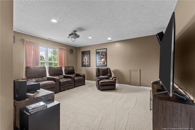 carpeted cinema with a textured ceiling, baseboards, and recessed lighting