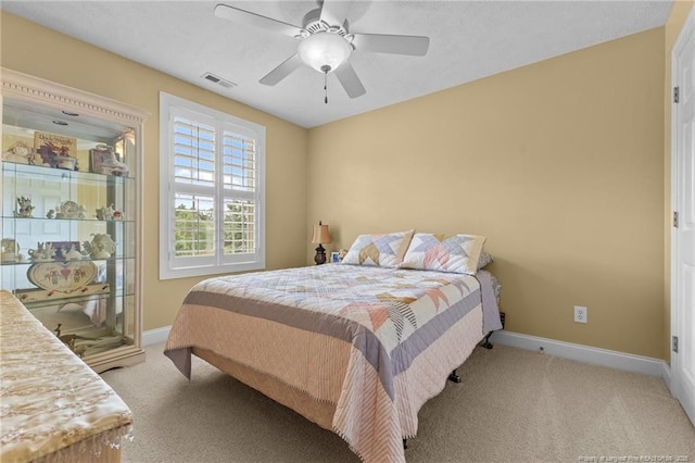 carpeted bedroom with baseboards and a ceiling fan