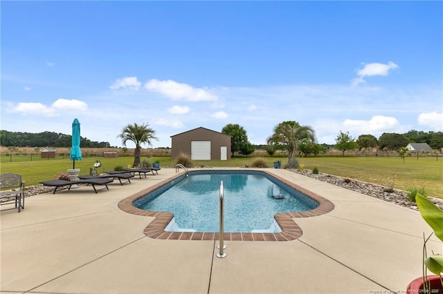 outdoor pool with a lawn, a patio area, and an outdoor structure