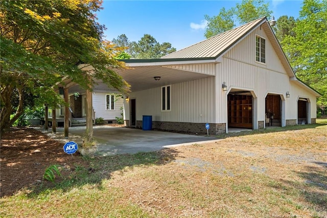 3229 Mcqueen Rd, Red Springs, NC 28377 - view of home's exterior with dirt driveway, a detached garage, and metal roof