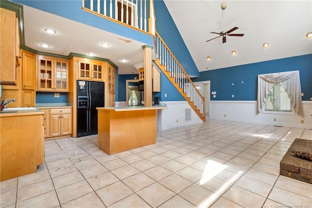 3229 Mcqueen Rd, Red Springs, NC 28377 - kitchen featuring black fridge with ice dispenser, open floor plan, a ceiling fan, wainscoting, and light tile patterned floors