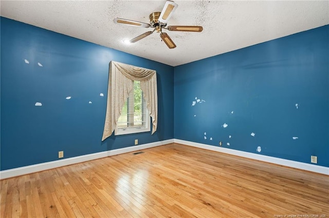 3229 Mcqueen Rd, Red Springs, NC 28377 - spare room with wood-type flooring, a ceiling fan, baseboards, and a textured ceiling