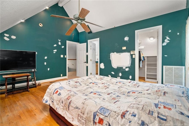 3229 Mcqueen Rd, Red Springs, NC 28377 - bedroom with hardwood / wood-style floors, baseboards, a walk in closet, beam ceiling, and high vaulted ceiling