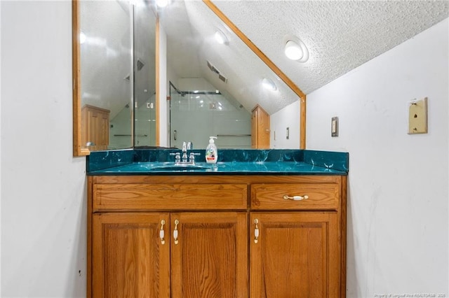 3229 Mcqueen Rd, Red Springs, NC 28377 - bathroom featuring lofted ceiling, a textured ceiling, an enclosed shower, and vanity