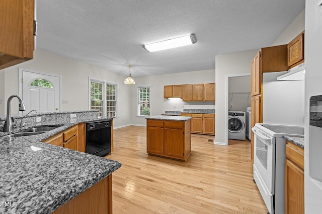 kitchen featuring black dishwasher, washer / clothes dryer, white electric range, a sink, and a center island