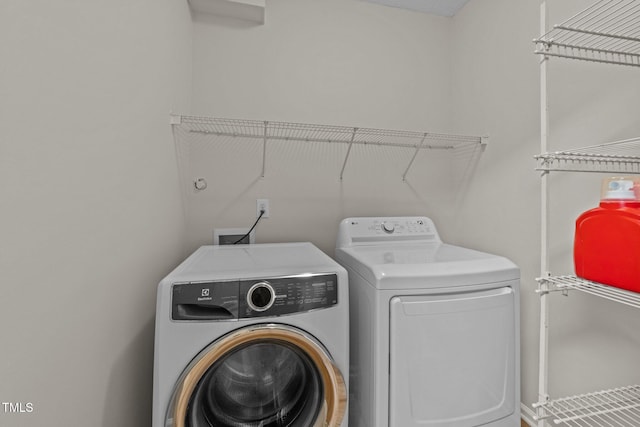 washroom with separate washer and dryer