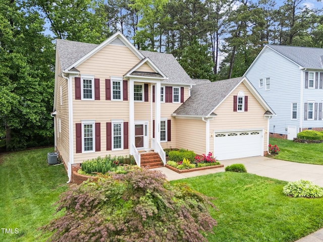 neoclassical / greek revival house with concrete driveway, a shingled roof, cooling unit, and a front lawn