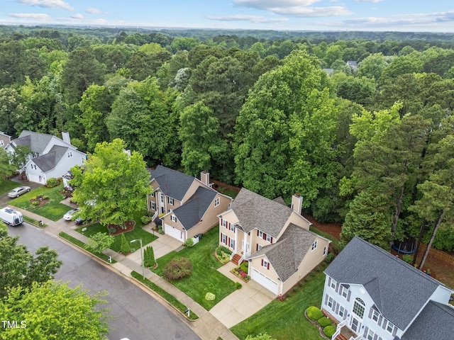 aerial perspective of suburban area with a forest