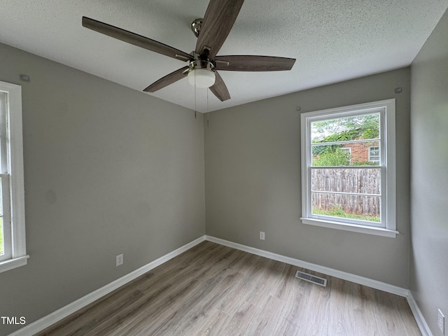 1064 Abbott Rd, Henderson, NC 27537 - unfurnished room featuring ceiling fan, wood finished floors, baseboards, and a textured ceiling