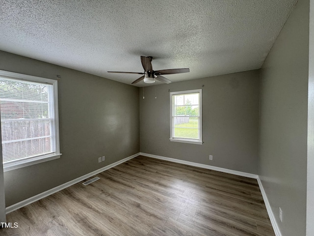 1064 Abbott Rd, Henderson, NC 27537 - unfurnished room with wood finished floors, ceiling fan, a textured ceiling, and baseboards
