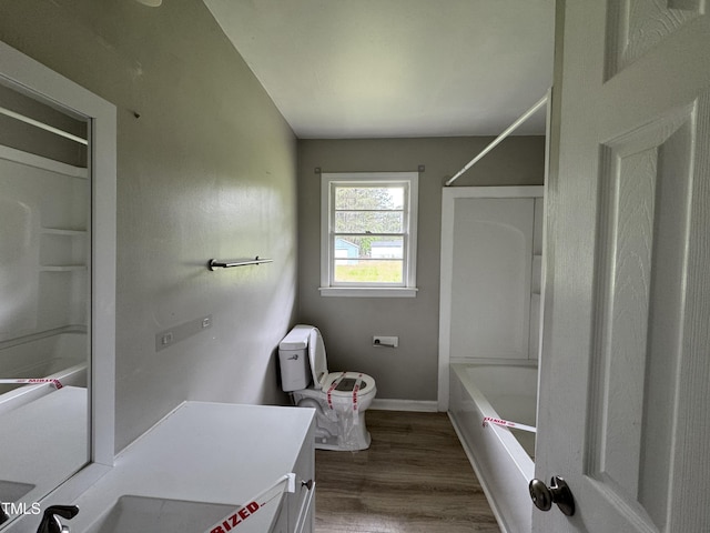 1064 Abbott Rd, Henderson, NC 27537 - bathroom featuring  shower combination, wood finished floors, vanity, toilet, and baseboards