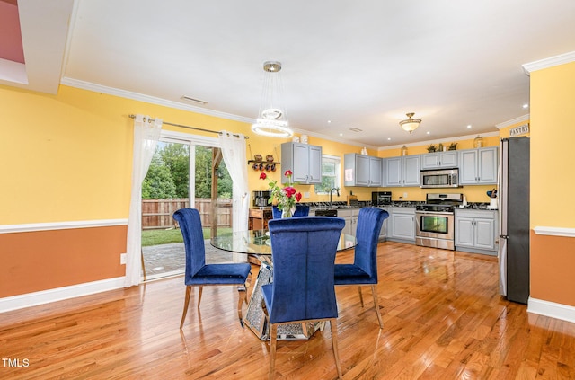412 Collington Dr, Mebane, NC 27302 - dining room featuring crown molding, light wood-style flooring, and baseboards