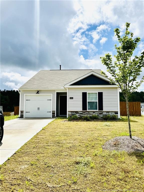 3202 Finch Ct, Sanford, NC 27332 - view of front of home with driveway, an attached garage, and stone siding