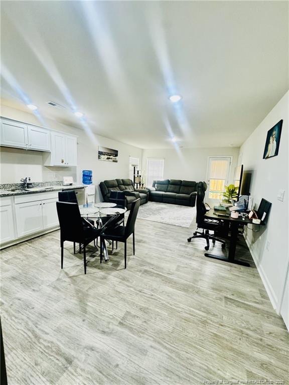 3202 Finch Ct, Sanford, NC 27332 - dining space featuring healthy amount of natural light and light wood-style floors