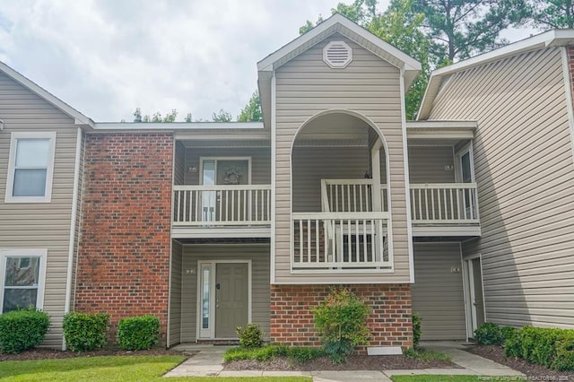 669 Bartons Landing Pl Unit 7, Fayetteville, NC 28314 - view of front facade with brick siding and a balcony