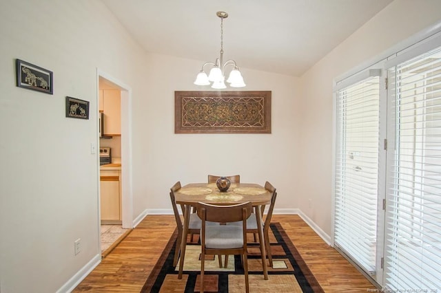 669 Bartons Landing Pl Unit 7, Fayetteville, NC 28314 - dining room with a chandelier, light wood-style floors, healthy amount of natural light, baseboards, and lofted ceiling