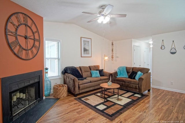 669 Bartons Landing Pl Unit 7, Fayetteville, NC 28314 - living room featuring wood finished floors, a ceiling fan, lofted ceiling, baseboards, and a fireplace