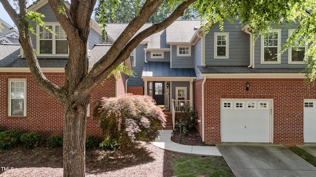 11013 Louson Pl, Raleigh, NC 27614 - view of front of home with brick siding, a garage, roof with shingles, and concrete driveway