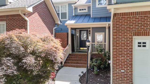 11013 Louson Pl, Raleigh, NC 27614 - view of exterior entry featuring brick siding, a shingled roof, and a garage