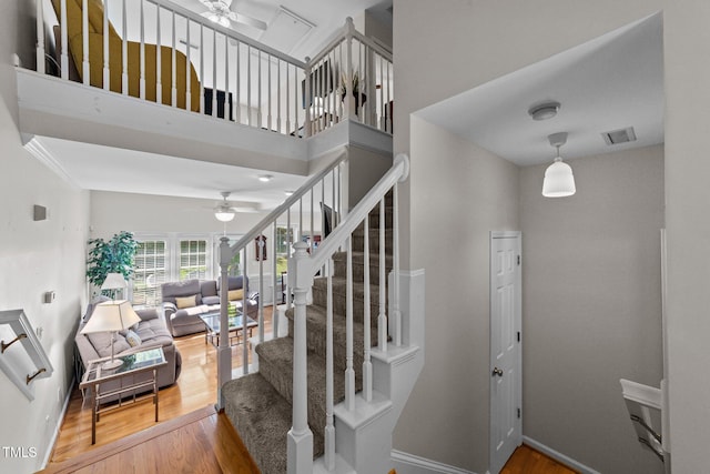11013 Louson Pl, Raleigh, NC 27614 - stairway with ceiling fan, wood finished floors, and baseboards