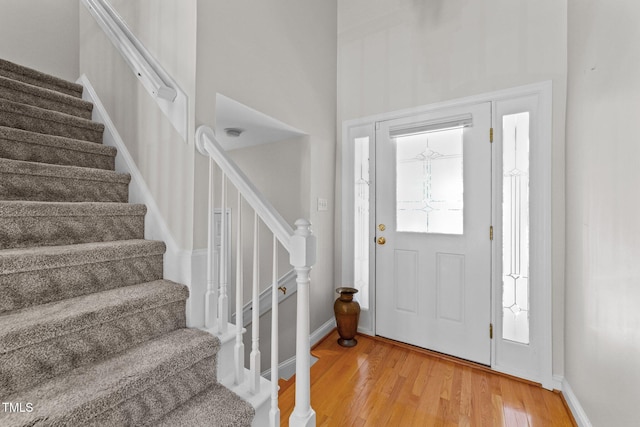 11013 Louson Pl, Raleigh, NC 27614 - foyer featuring stairs, light wood-style flooring, and baseboards