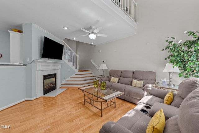 11013 Louson Pl, Raleigh, NC 27614 - living area with ceiling fan, a fireplace, light wood-style floors, stairway, and baseboards
