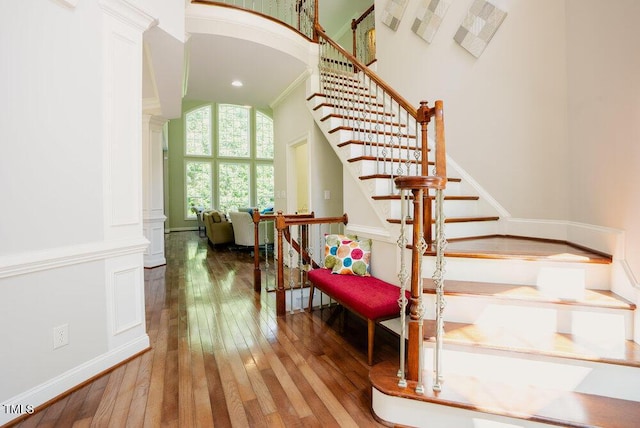 3911 Morvan Way, Raleigh, NC 27612 - stairs with hardwood / wood-style flooring, decorative columns, and a high ceiling