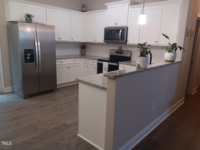 31 Kevior Ave, Four Oaks, NC 27524 - kitchen with appliances with stainless steel finishes, dark wood-style flooring, light stone countertops, white cabinets, and a peninsula