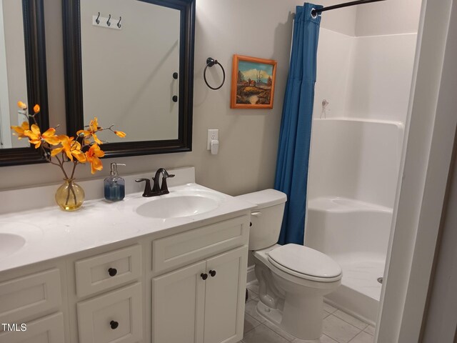 31 Kevior Ave, Four Oaks, NC 27524 - bathroom with a shower stall, toilet, tile patterned floors, and double vanity