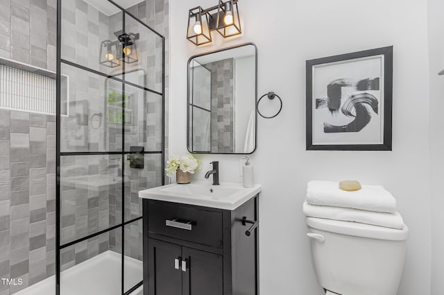 bathroom featuring a stall shower, vanity, and toilet