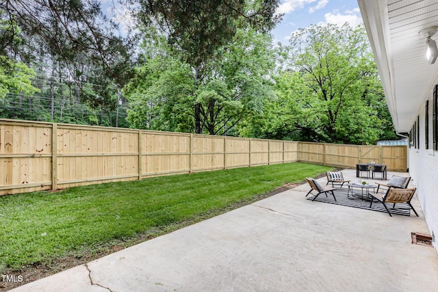 view of patio / terrace featuring view of wooded area