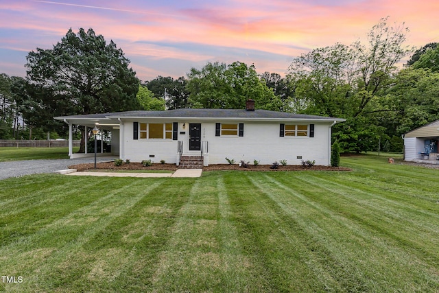 ranch-style house with driveway, crawl space, a chimney, view of scattered trees, and an attached carport
