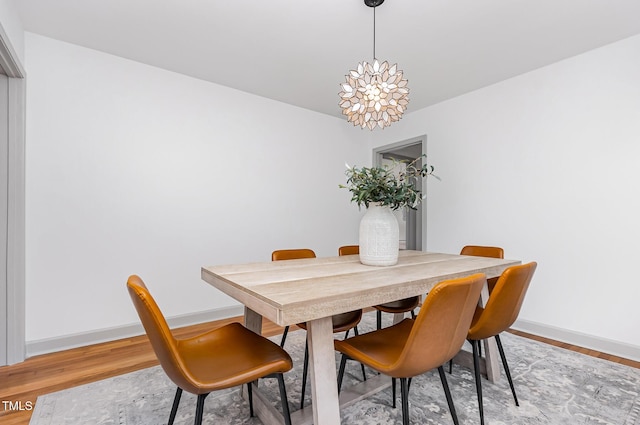 2205 W Carver St, Durham, NC 27705 - dining room with baseboards, light wood-type flooring, and a chandelier