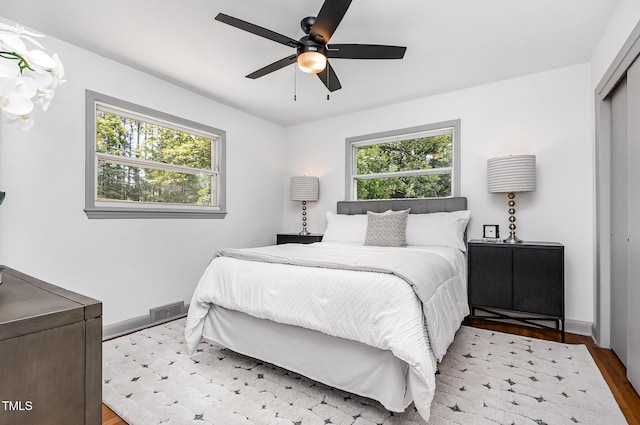 2205 W Carver St, Durham, NC 27705 - bedroom with wood finished floors, a closet, baseboards, and a ceiling fan
