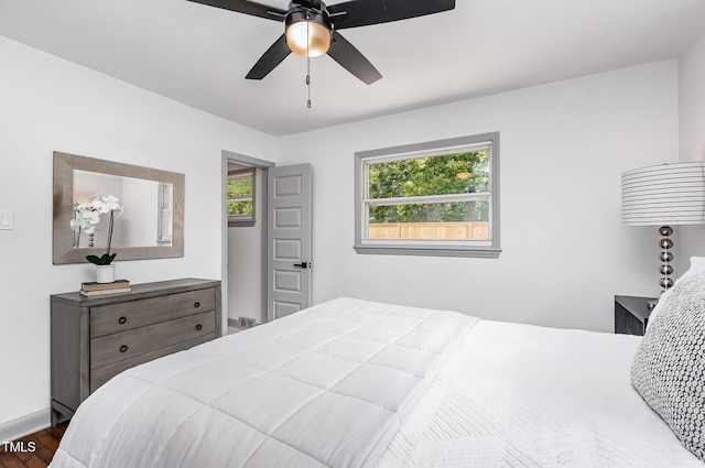 2205 W Carver St, Durham, NC 27705 - bedroom with dark wood-type flooring, a ceiling fan, and baseboards