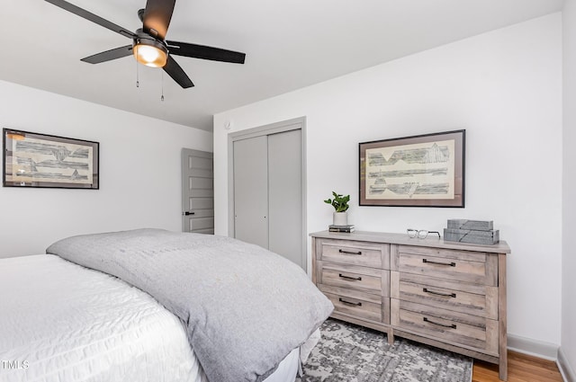 2205 W Carver St, Durham, NC 27705 - bedroom with a closet, light wood finished floors, a ceiling fan, and baseboards