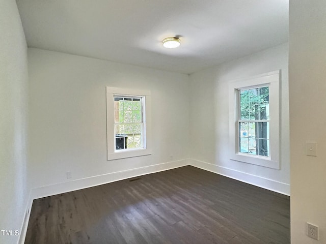114 N Guthrie Ave, Durham, NC 27703 - empty room featuring dark wood-type flooring, healthy amount of natural light, and baseboards