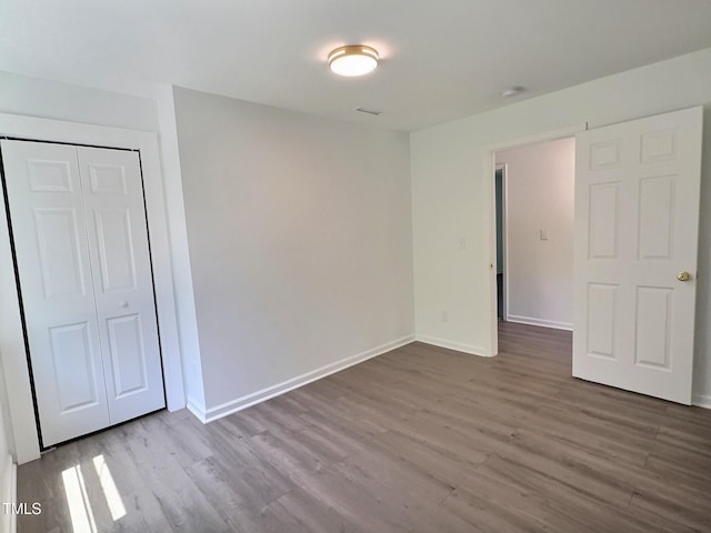114 N Guthrie Ave, Durham, NC 27703 - unfurnished bedroom with wood finished floors, baseboards, and a closet