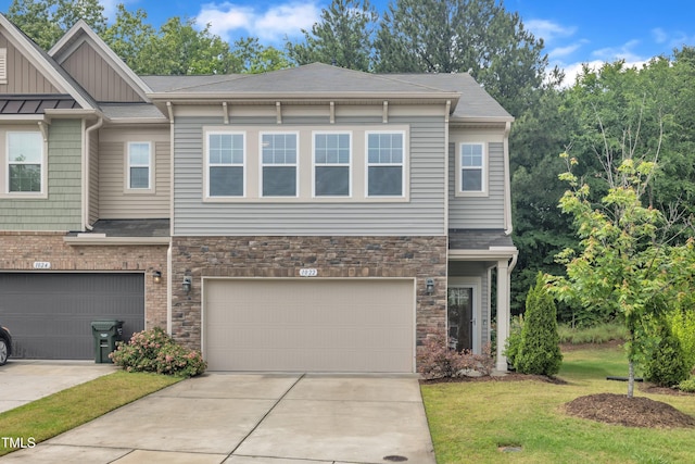 view of front of home with stone siding, a front lawn, a garage, board and batten siding, and driveway