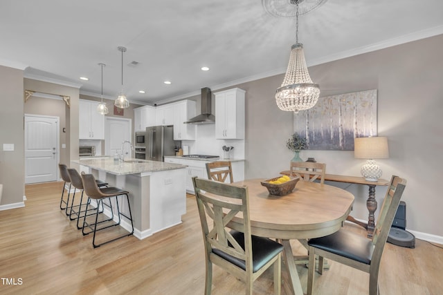 dining room with ornamental molding, a chandelier, light wood-style flooring, recessed lighting, and baseboards