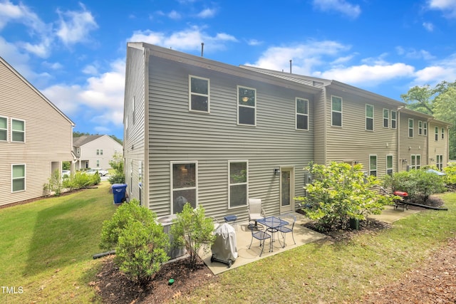 rear view of property featuring a patio and a yard