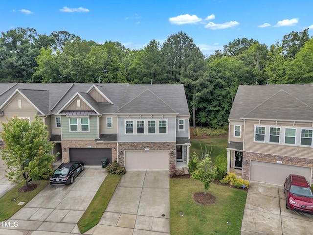 view of property featuring driveway, stone siding, an attached garage, and a front yard