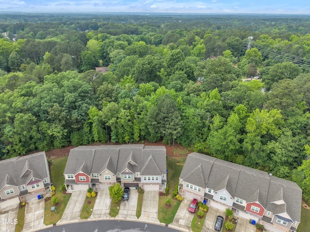aerial view of residential area featuring a forest